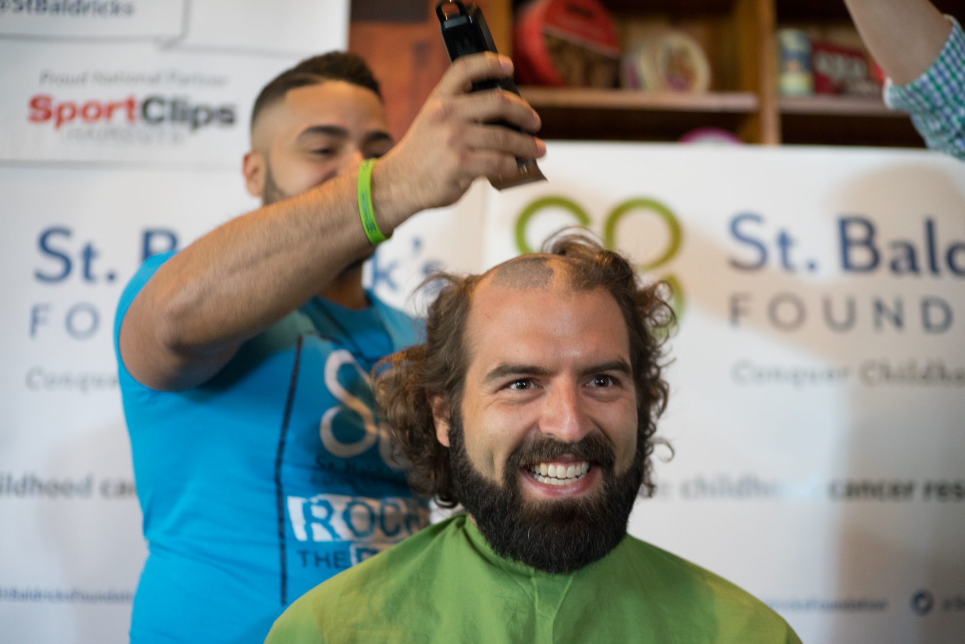 a man getting his head shaved