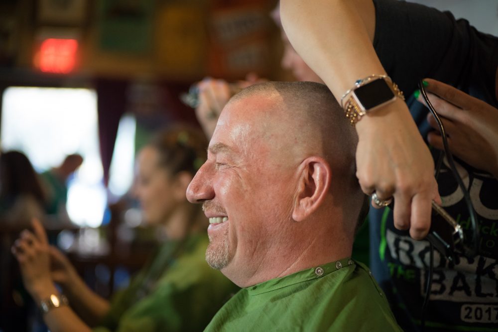 a man getting his head shaved