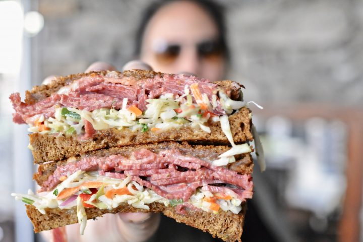 a woman holding a delicious looking [pub_info] sandwich